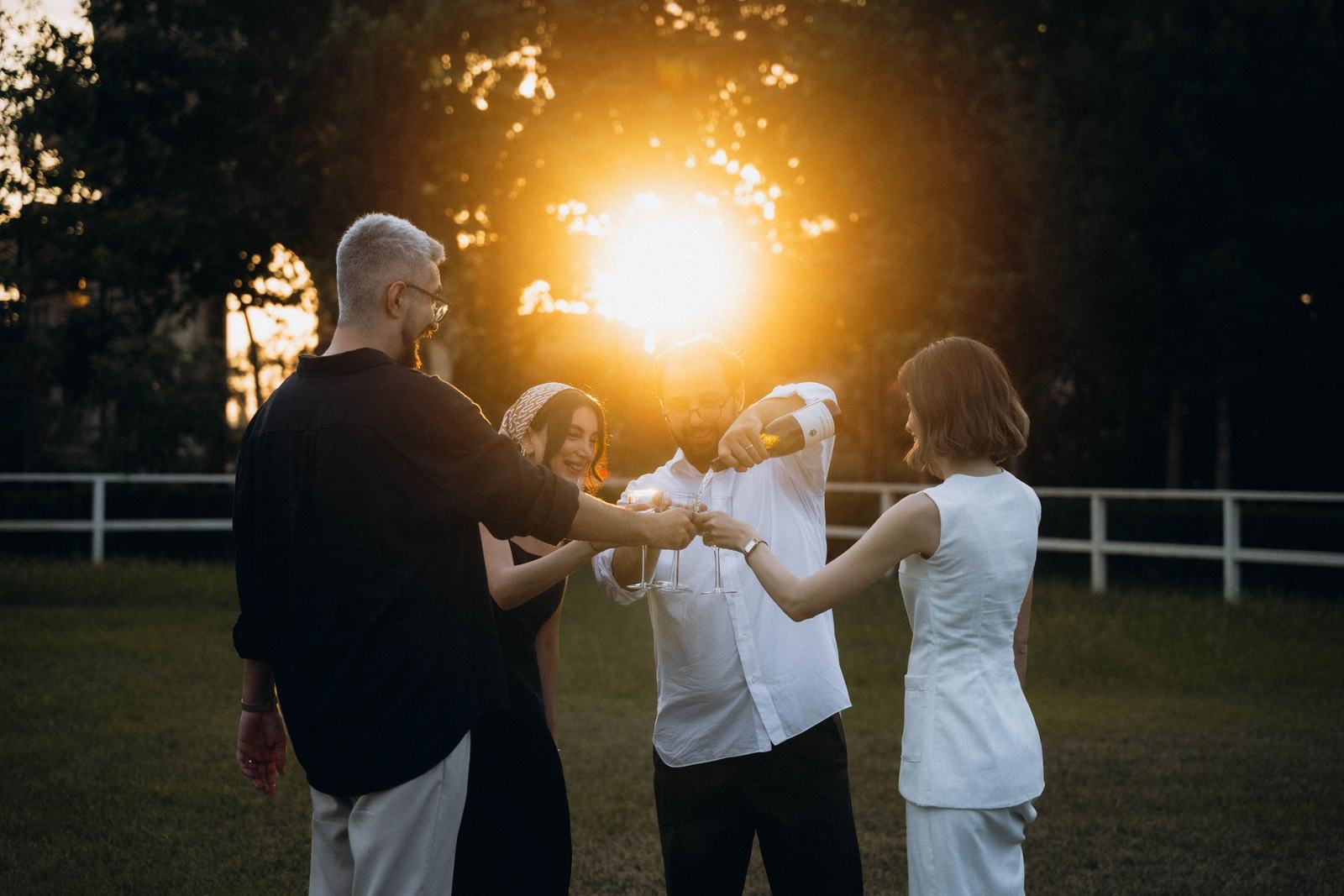 A group of friends raising a toast at sunset
